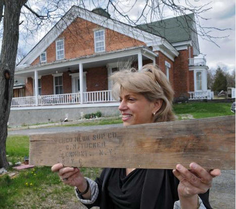 Amy Musiker holds a piece of wood she found in her home, with the name of a former owner of the home, Gilbert M. Tucker Jr., who lived there after he survived the sinking of the Titanic on April 15, 1912, on Tuesday April 10, 2012 in Glenmont, NY. (Philip Kamrass / Times Union ) 